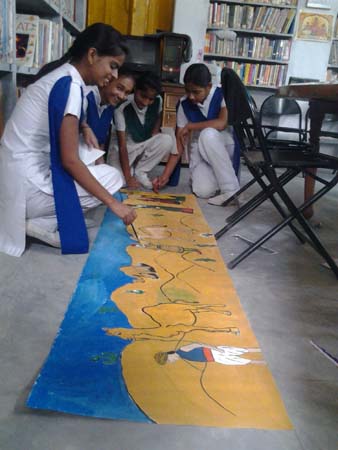 Girls are making a  painting