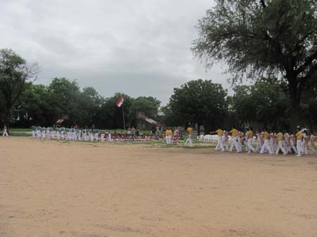 The students participating in a the Parade on the ground